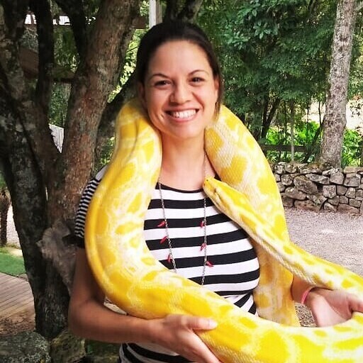 a photo of a woman holding a snake around her body
