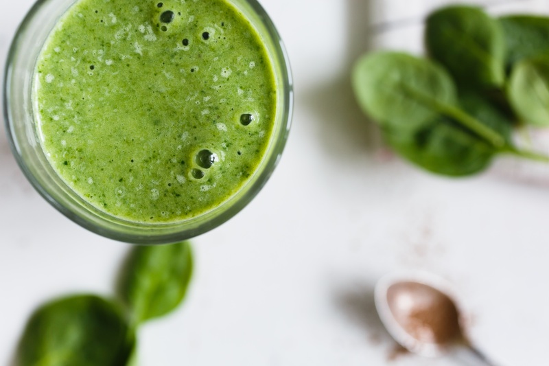 a glass of green vegetable smoothie