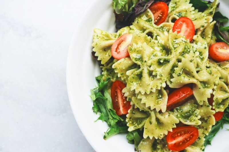 a plate with pasta with vegan pesto sauce