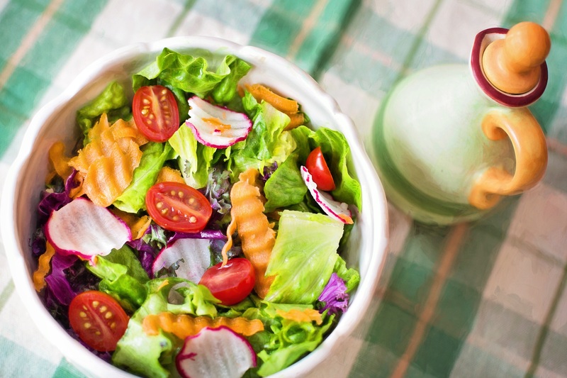 a colorful salad with green leaves and vegetables